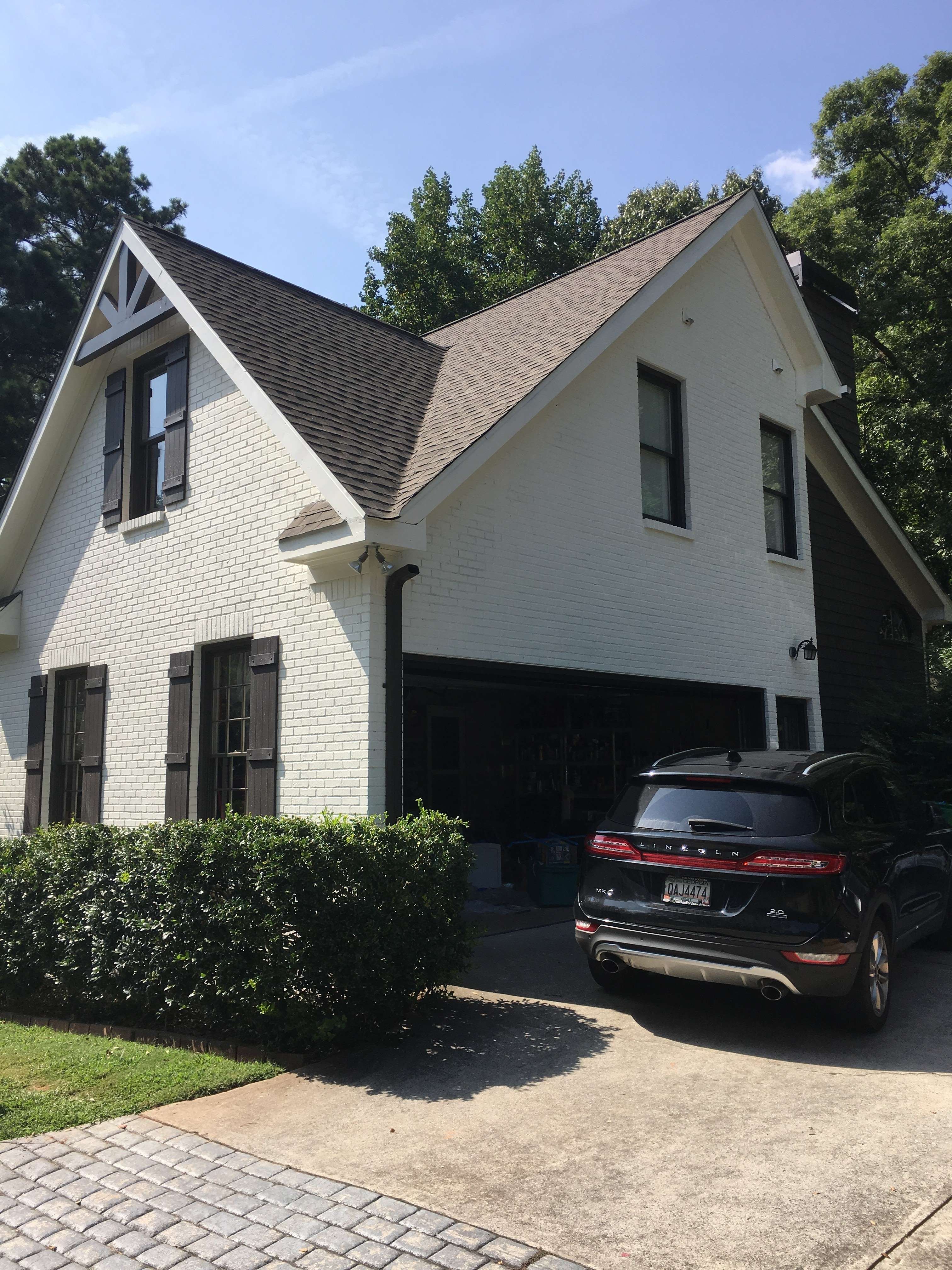 Two-story home exterior repaint with crisp white trim