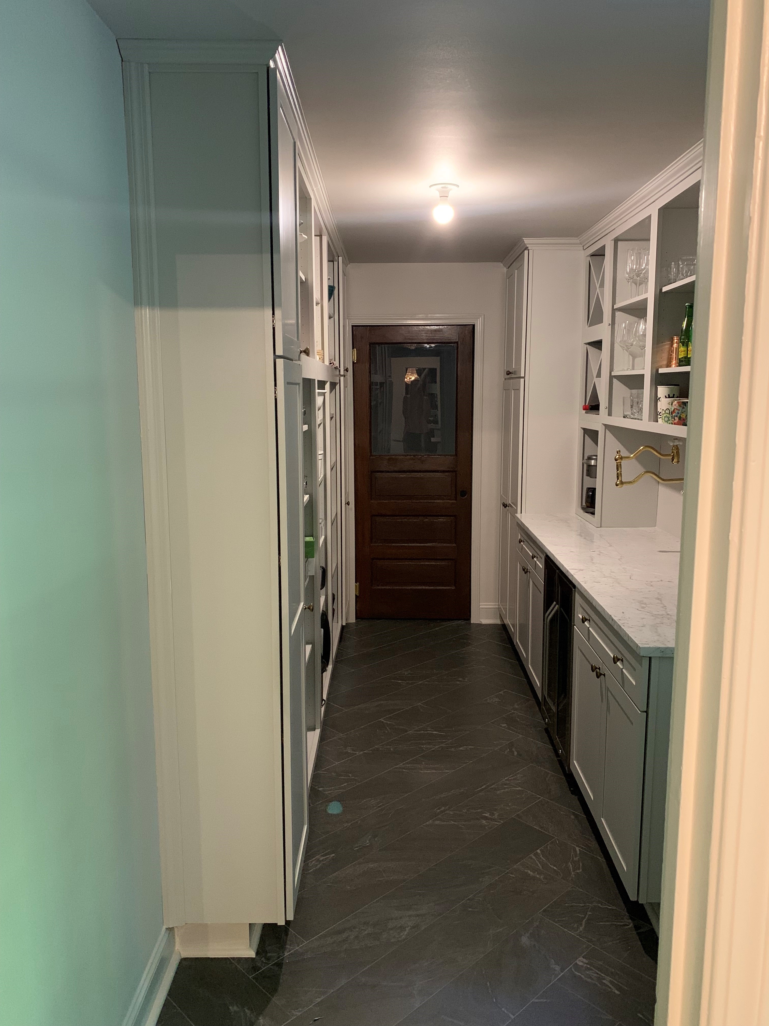 Freshly refinished white pantry cabinets