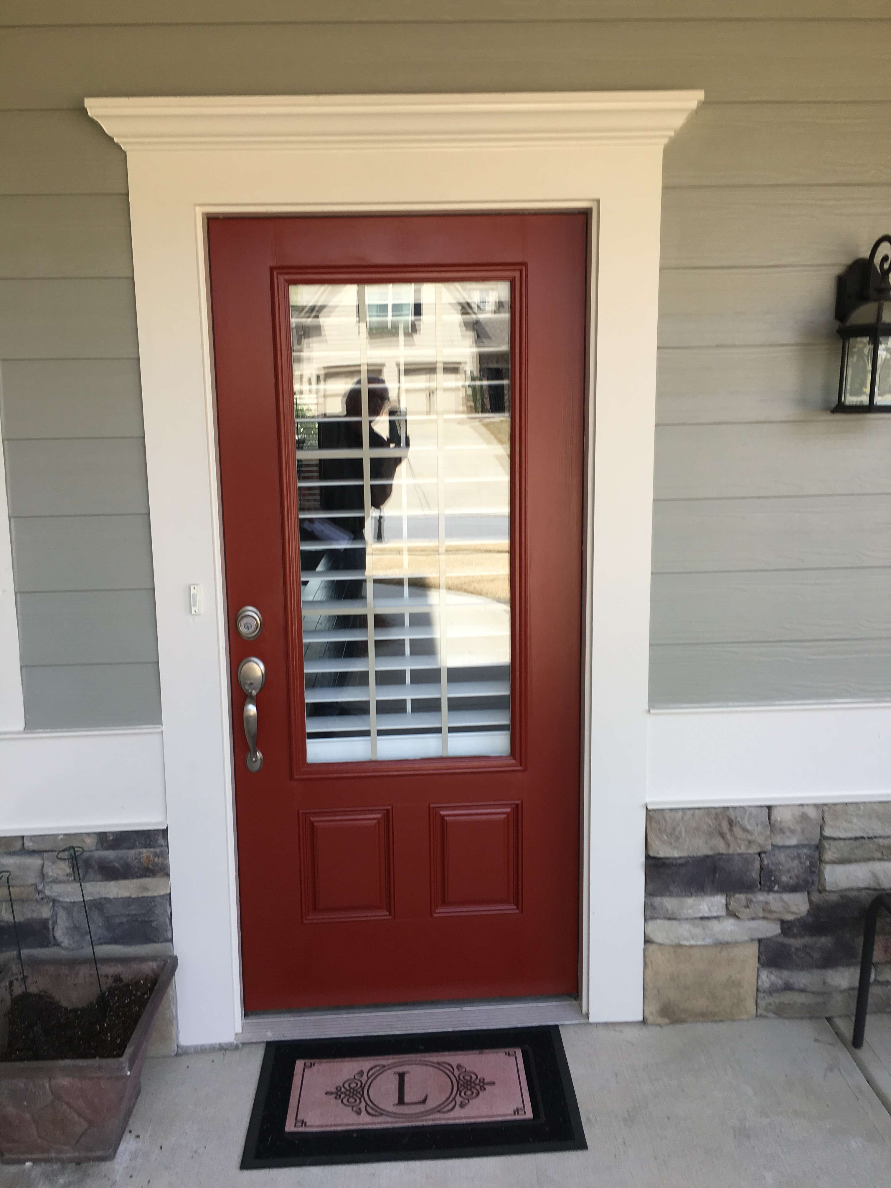Front entry with painted red door and white trim