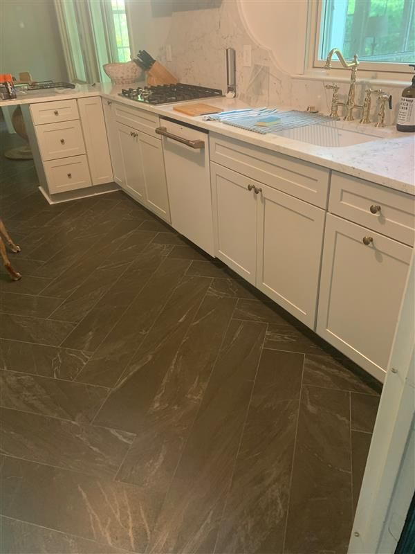 Kitchen with white shaker cabinets and tile floor