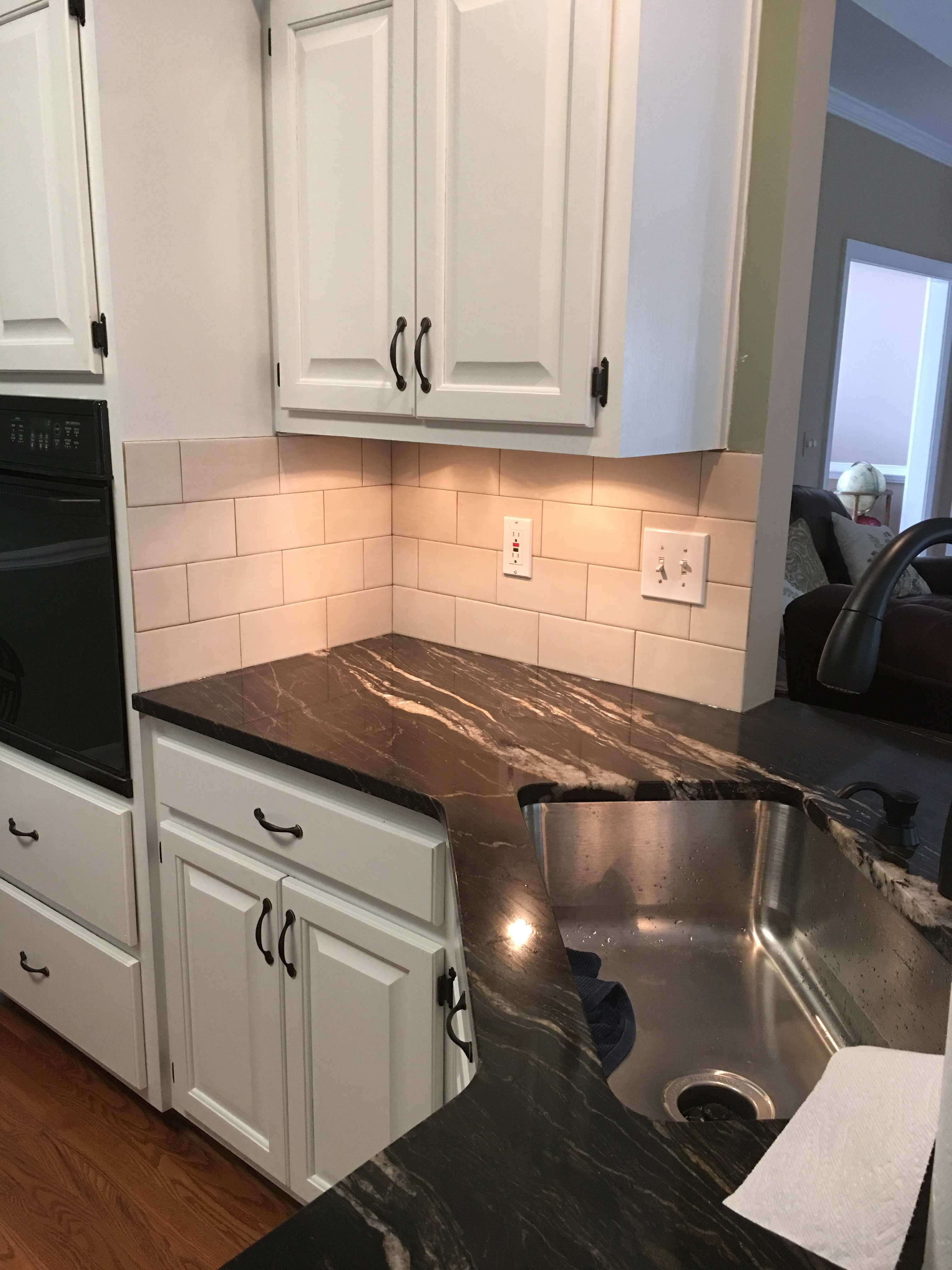 Kitchen repaint with white cabinets and dark stone counters